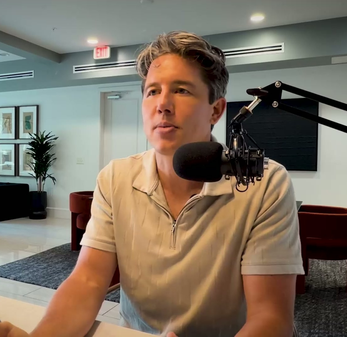 Matt Barge recording at desk with microphone